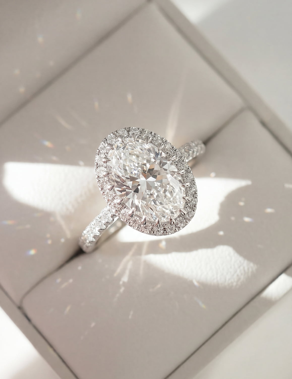 Close-up of an oval halo diamond engagement ring for custom ring design inspiration